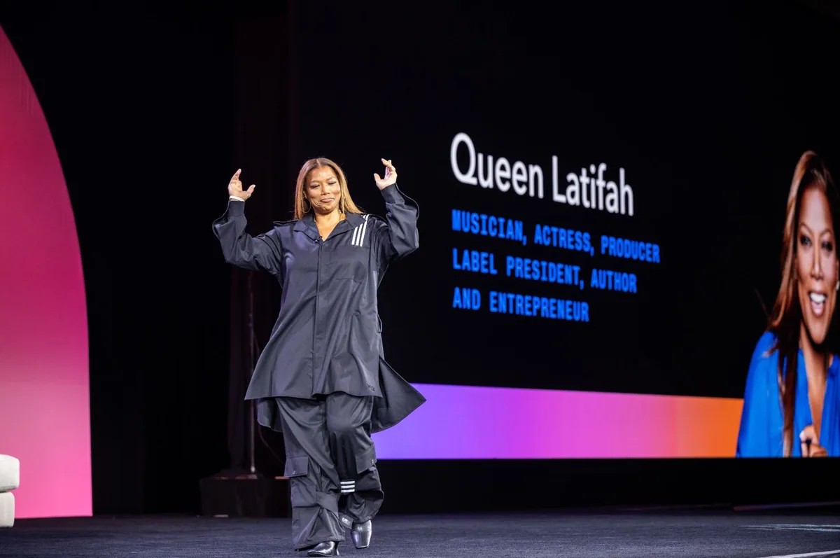 Headliner on stage in front of a large name graphic