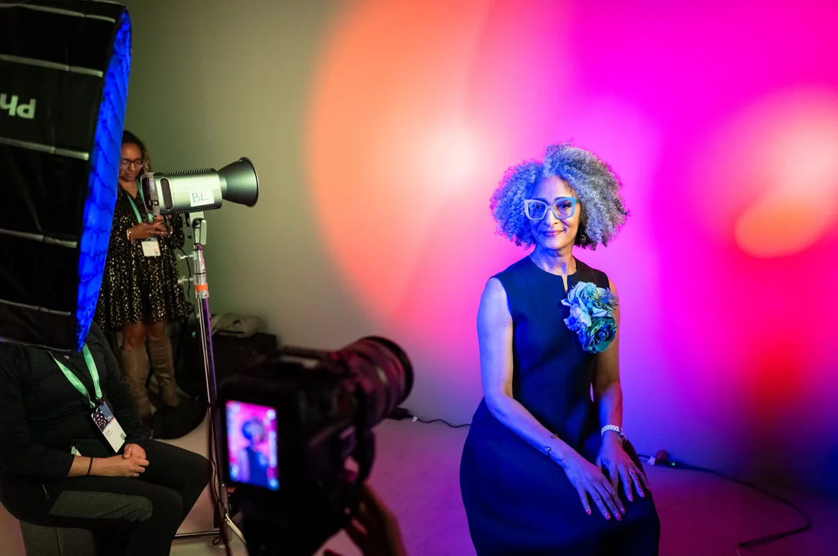 Attendee posing in a colorful photo booth
