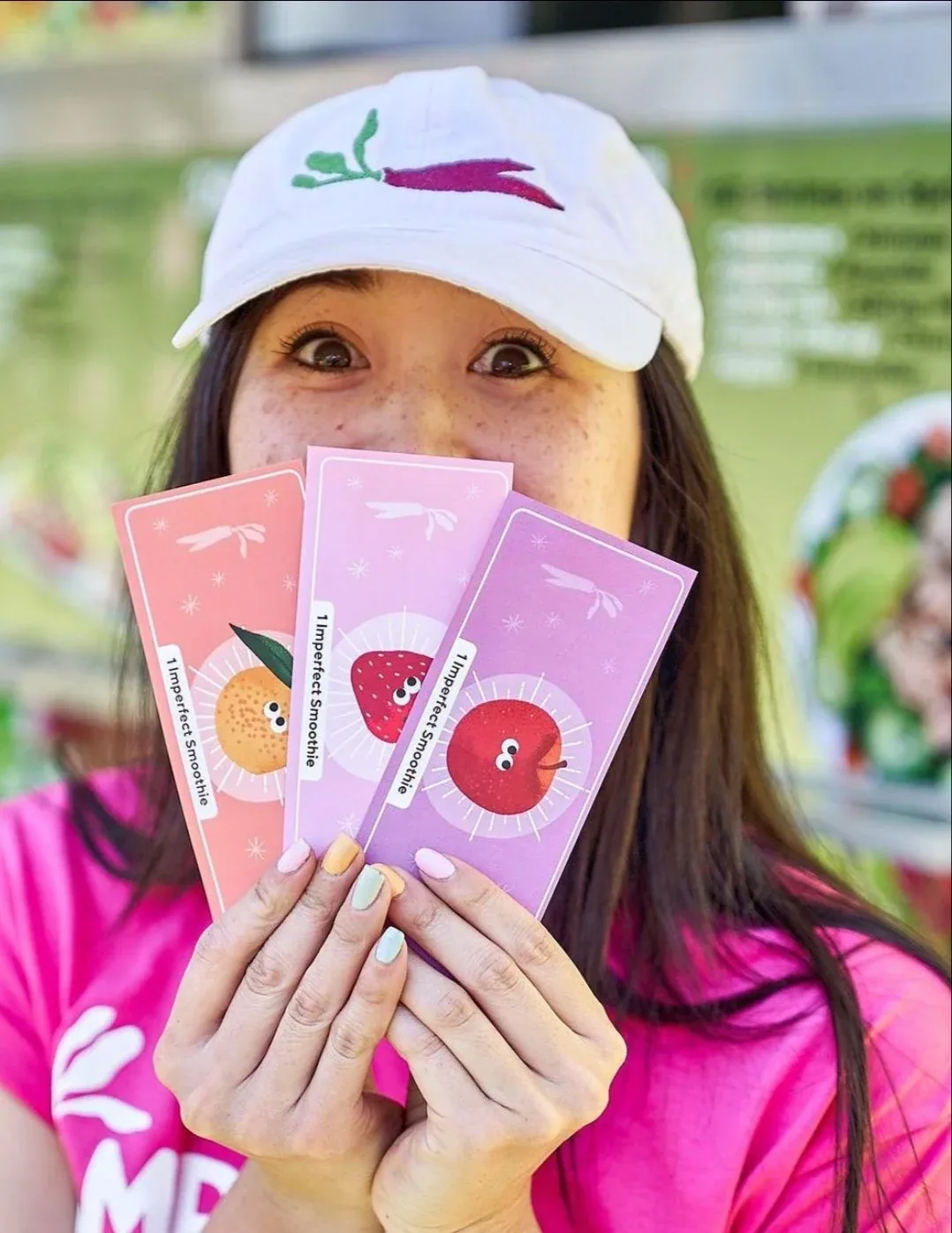 Attendee holding illustrated Imperfect Smoothie tokens
