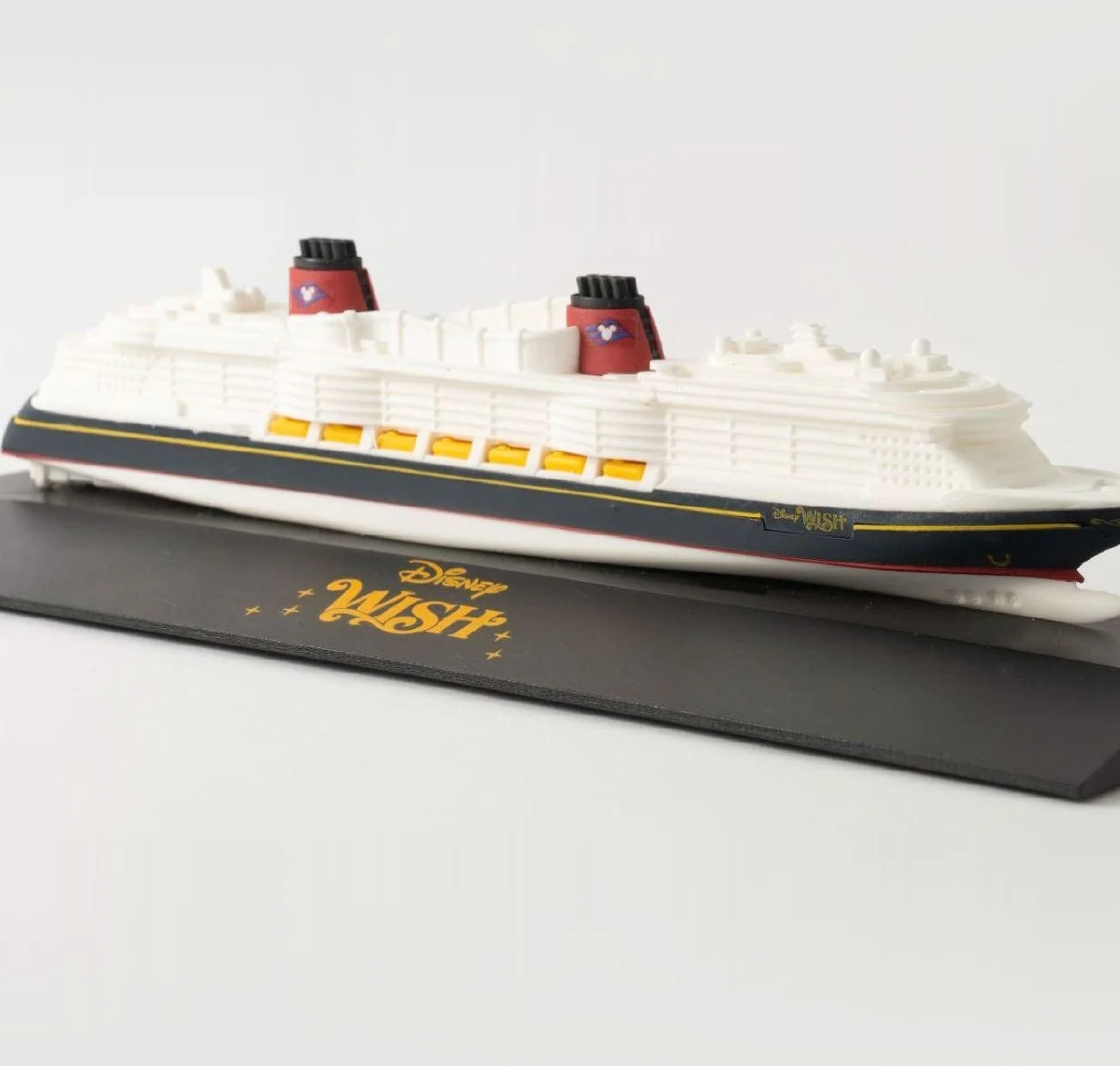 Model of the Disney Wish cruise ship on a black base