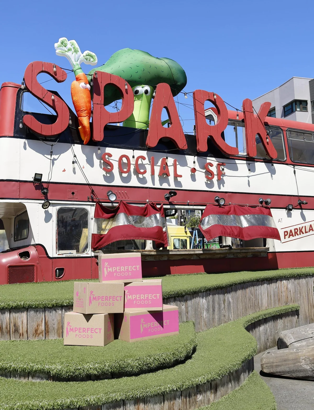 Imperfect Foods pop-up boxes beneath the Spark Social sign in San Francisco