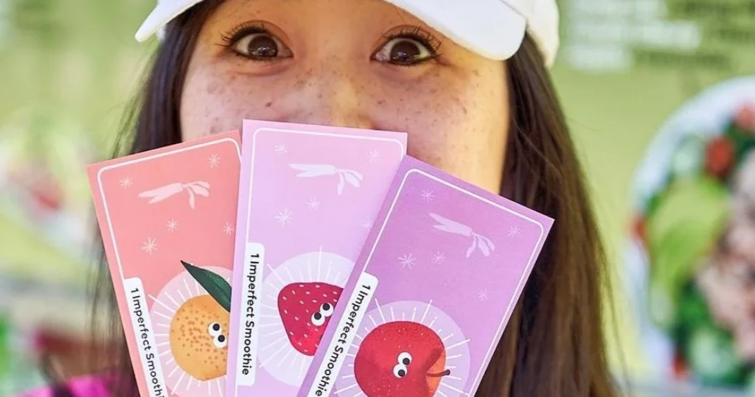 Attendee holding illustrated Imperfect Smoothie tokens